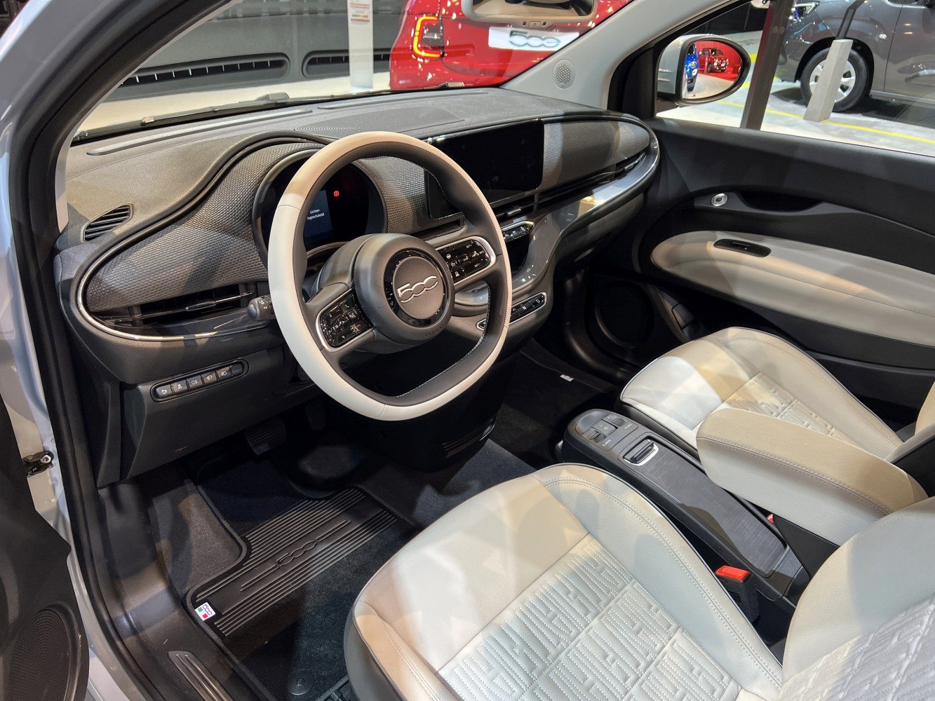 Modern dashboard and steering wheel with light-colored seats