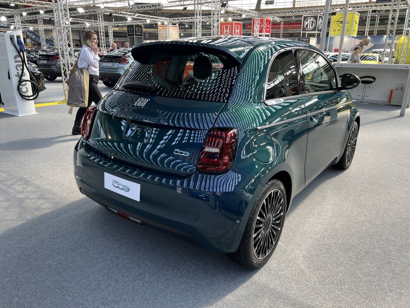 Rear side view of compact electric vehicle with sleek taillights and multi-spoke wheels