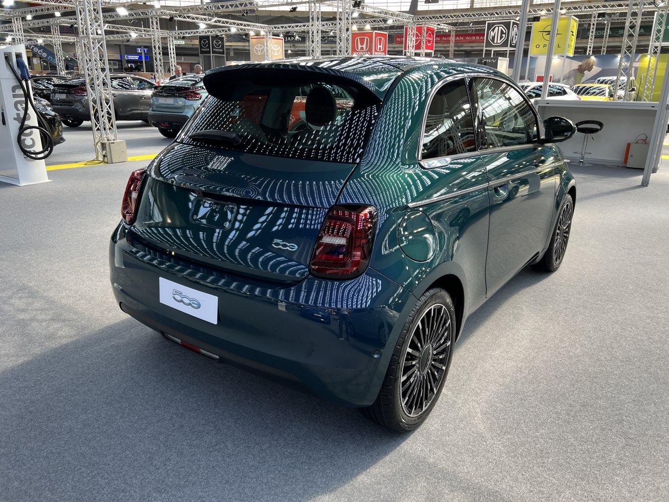 Rear view of a compact electric hatchback with distinct tail lights and multi-spoke wheels