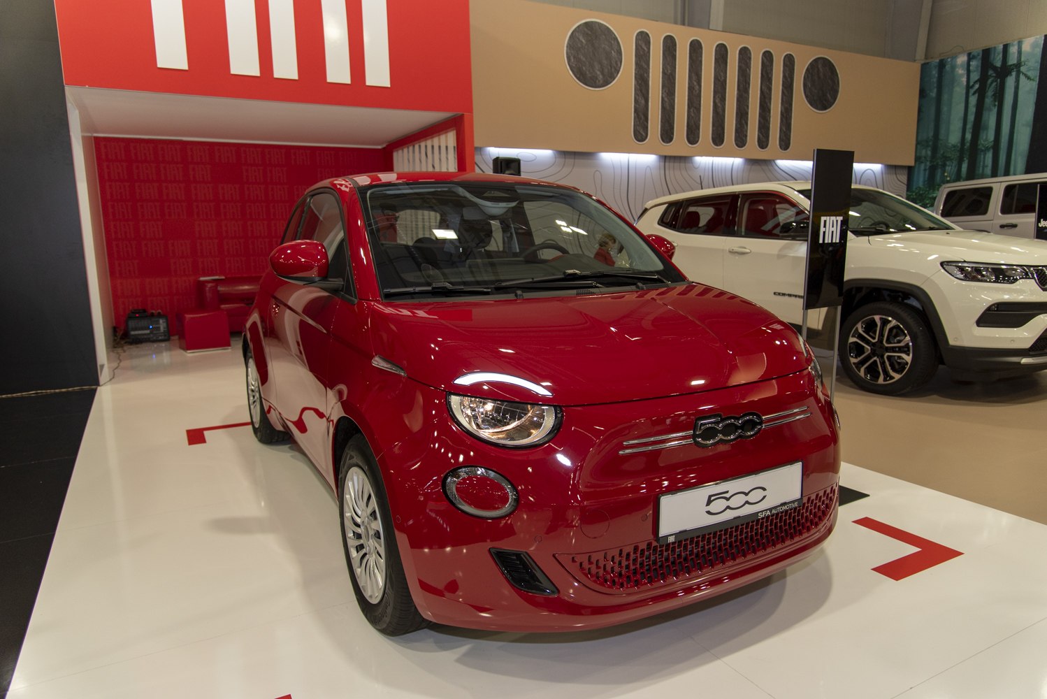 Red compact electric car with round headlights and modern front design
