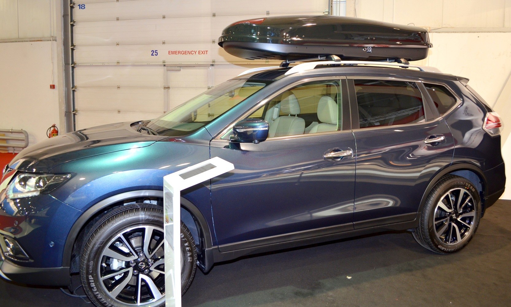 SUV side view with alloy wheels and roof cargo box