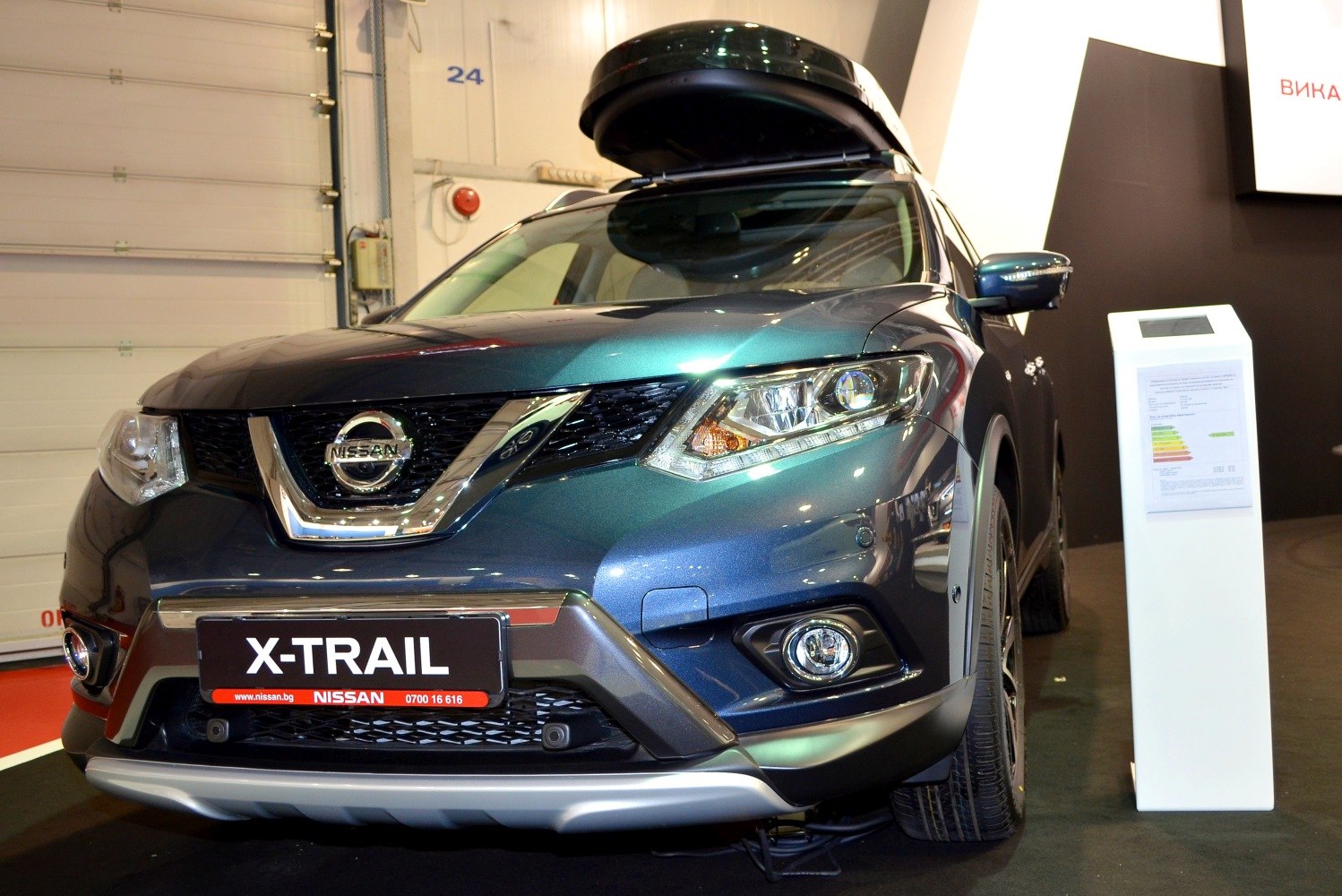 Front view of SUV with open roof box and distinctive headlights