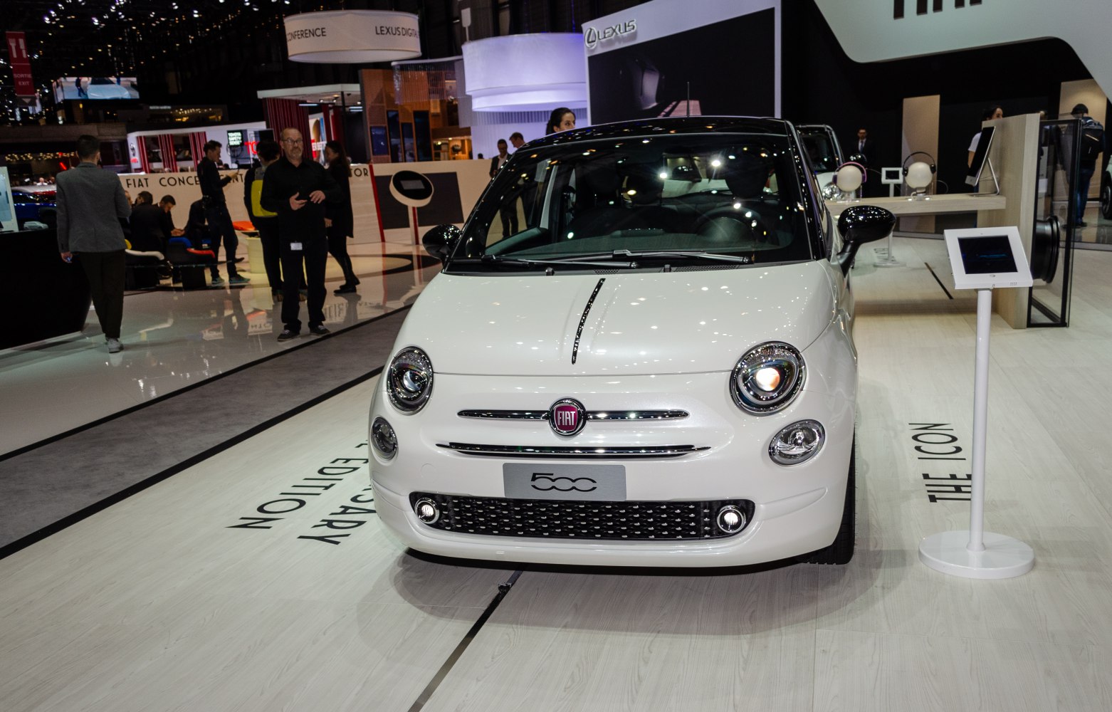 Front view of a compact car with round headlights and black roof.