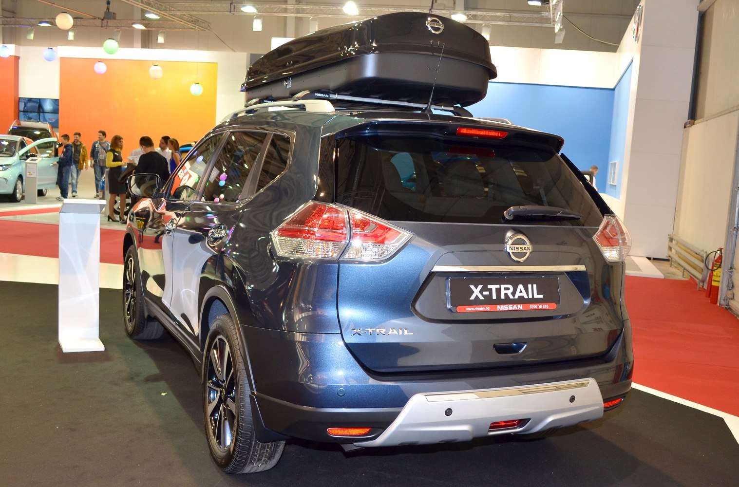 SUV rear view with rooftop cargo box and taillights