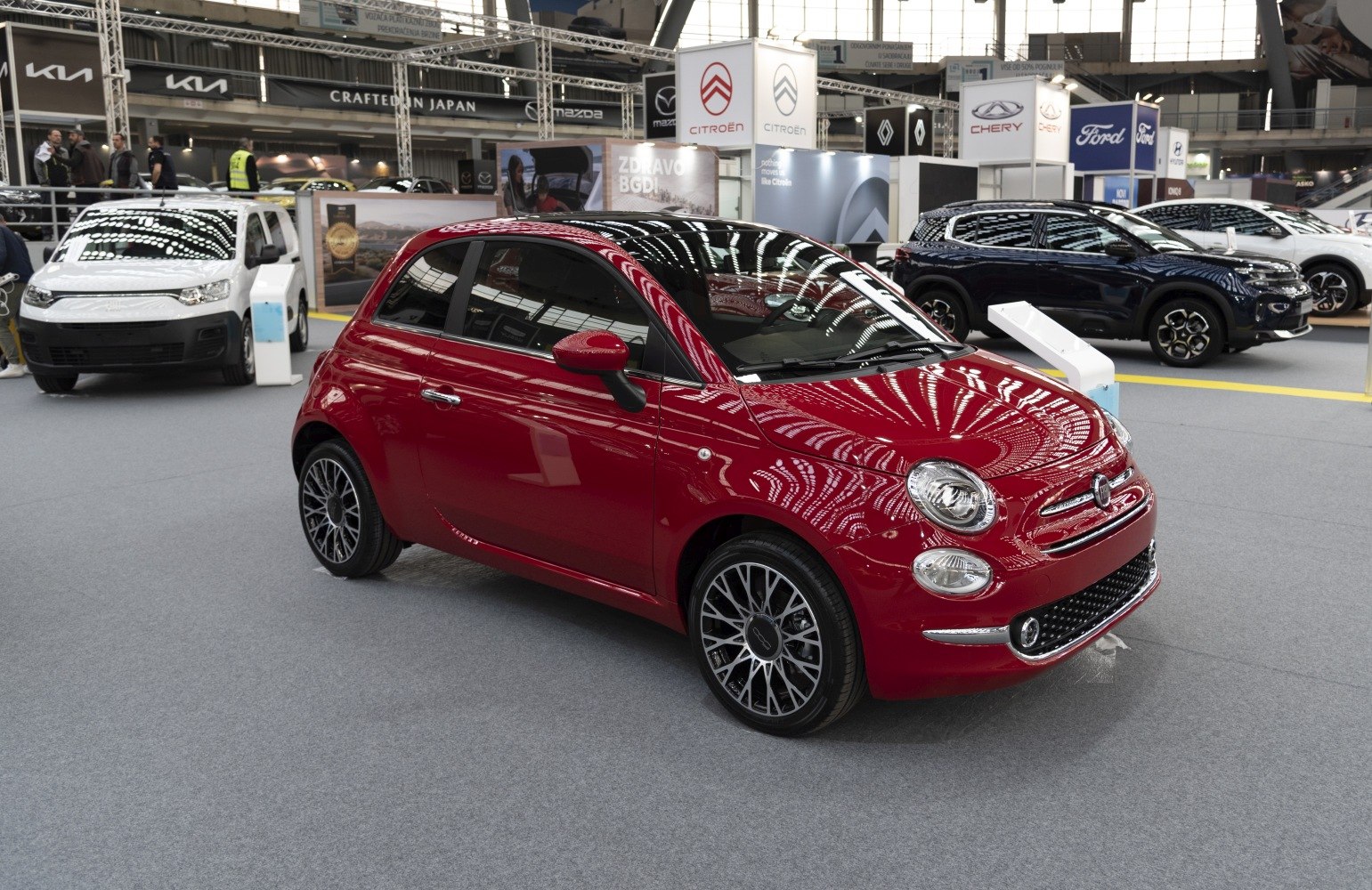 Red compact hatchback with alloy wheels and rounded headlights