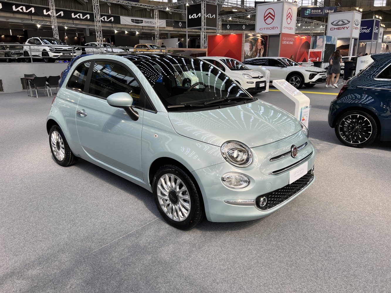Compact car with round headlights and chrome trim in front view