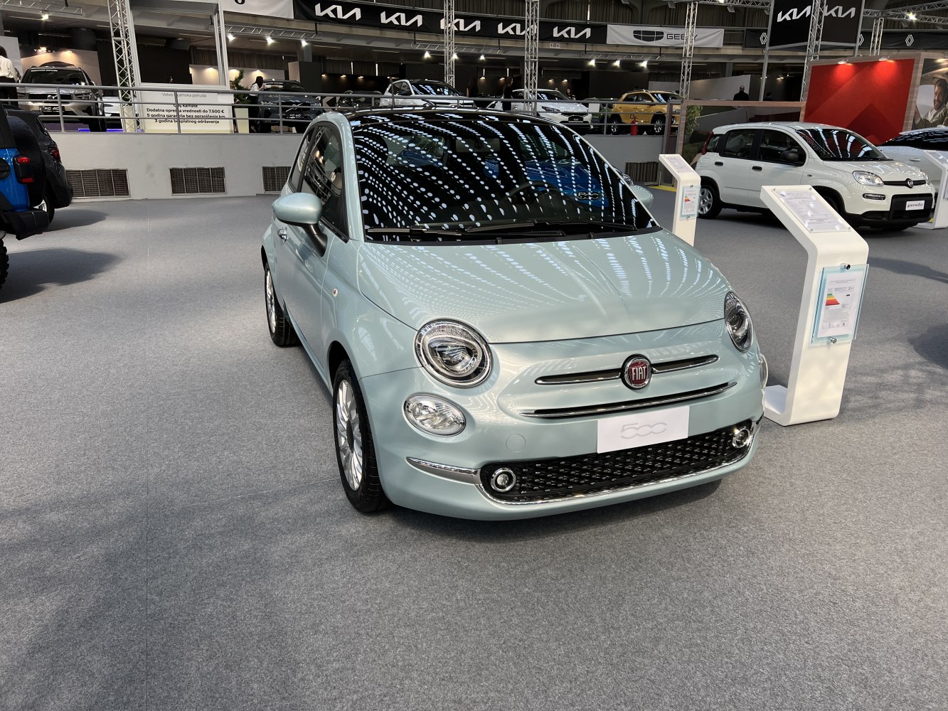 Round headlights and chrome-accented front grille with compact car shape