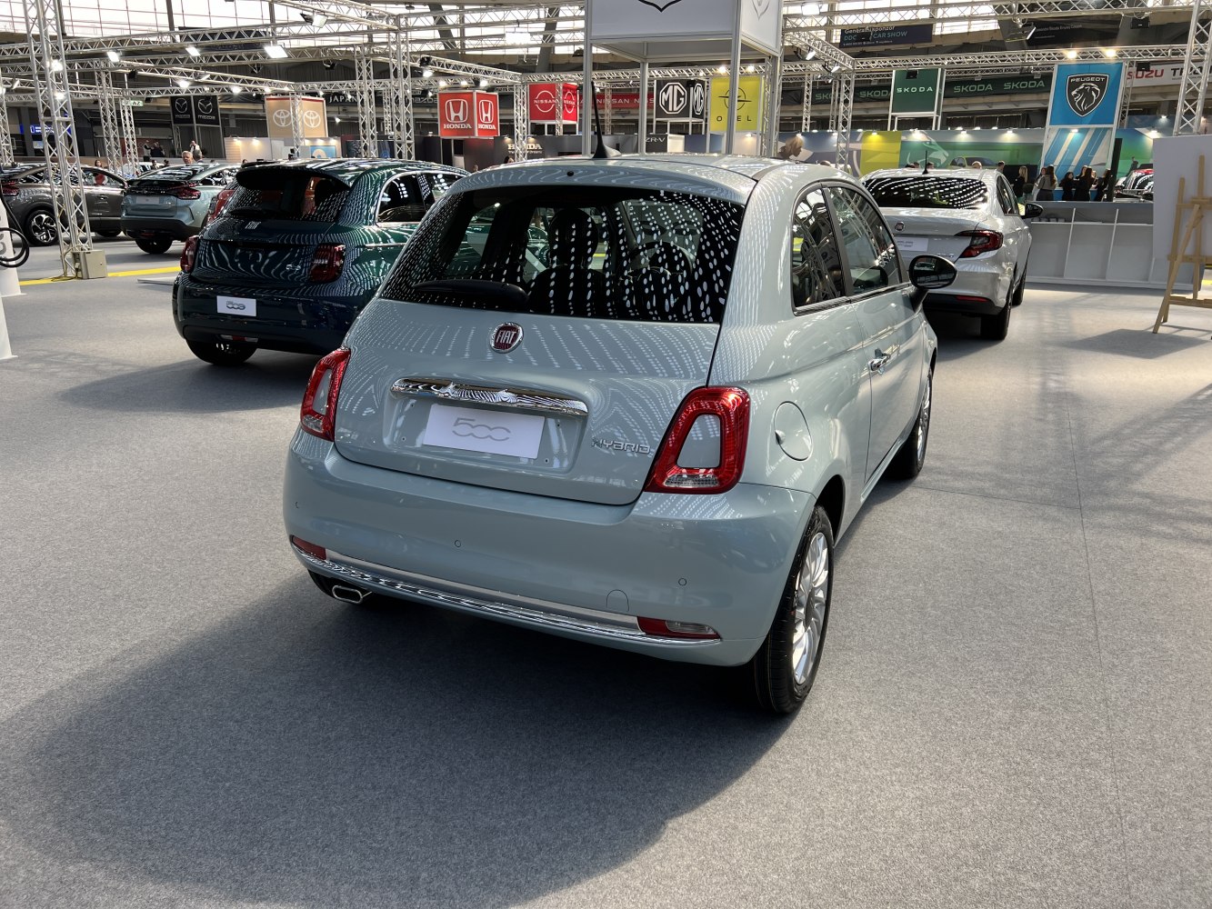 Compact hatchback rear view with hybrid badge and chrome trim