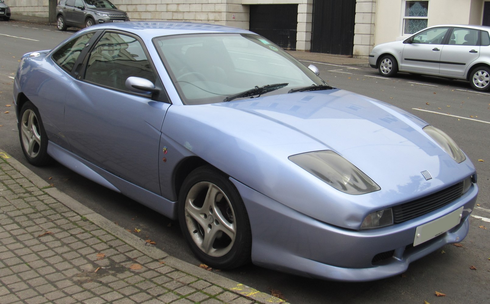 Light blue sporty coupe with distinctive headlights and aerodynamic design
