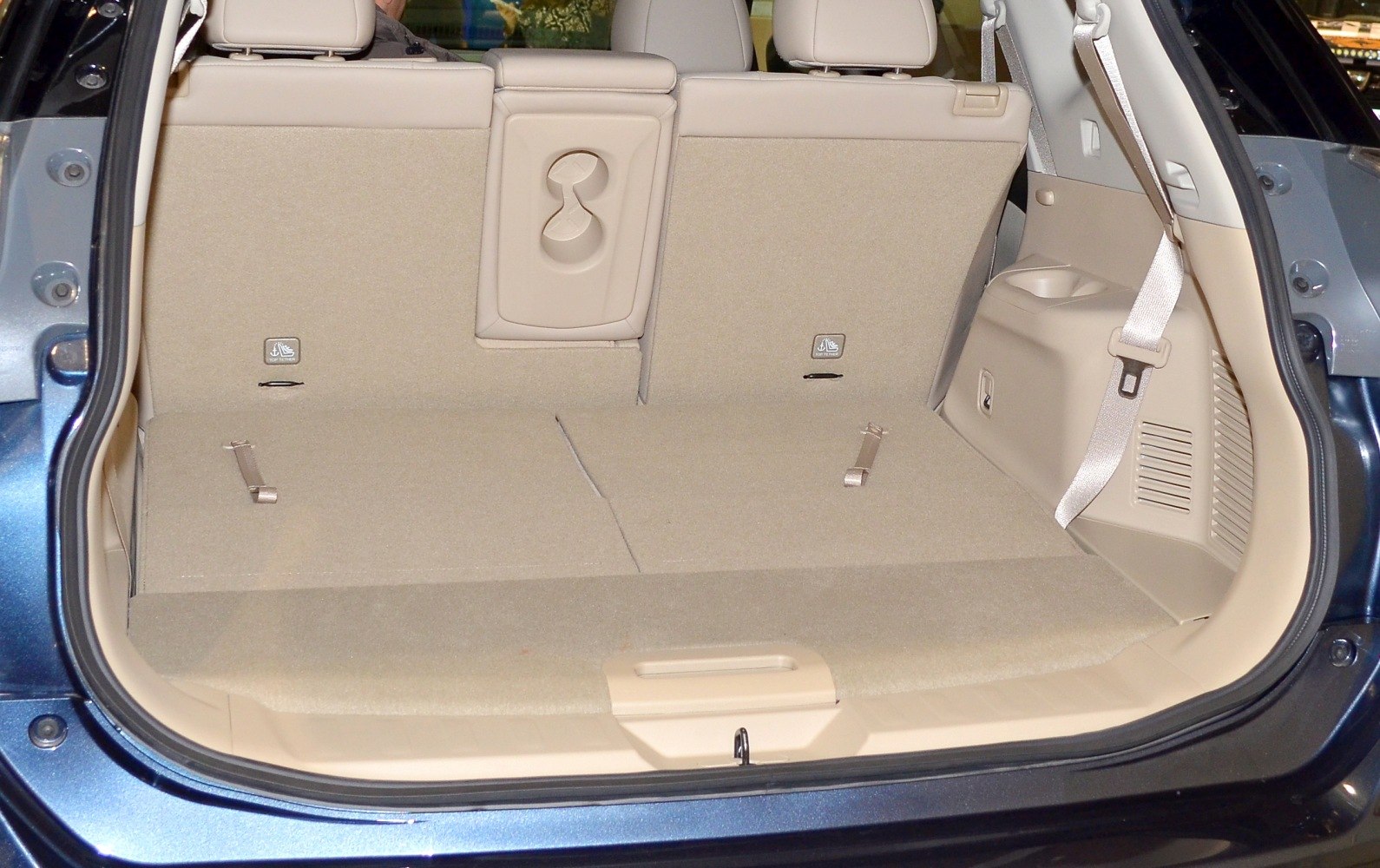 Spacious rear cargo area with foldable seats and beige upholstery