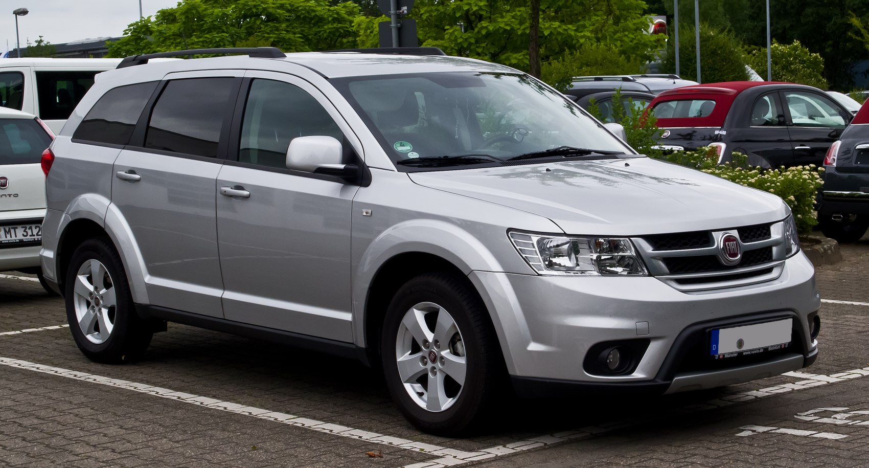 Silver mid-size SUV front-side view with alloy wheels and roof rails