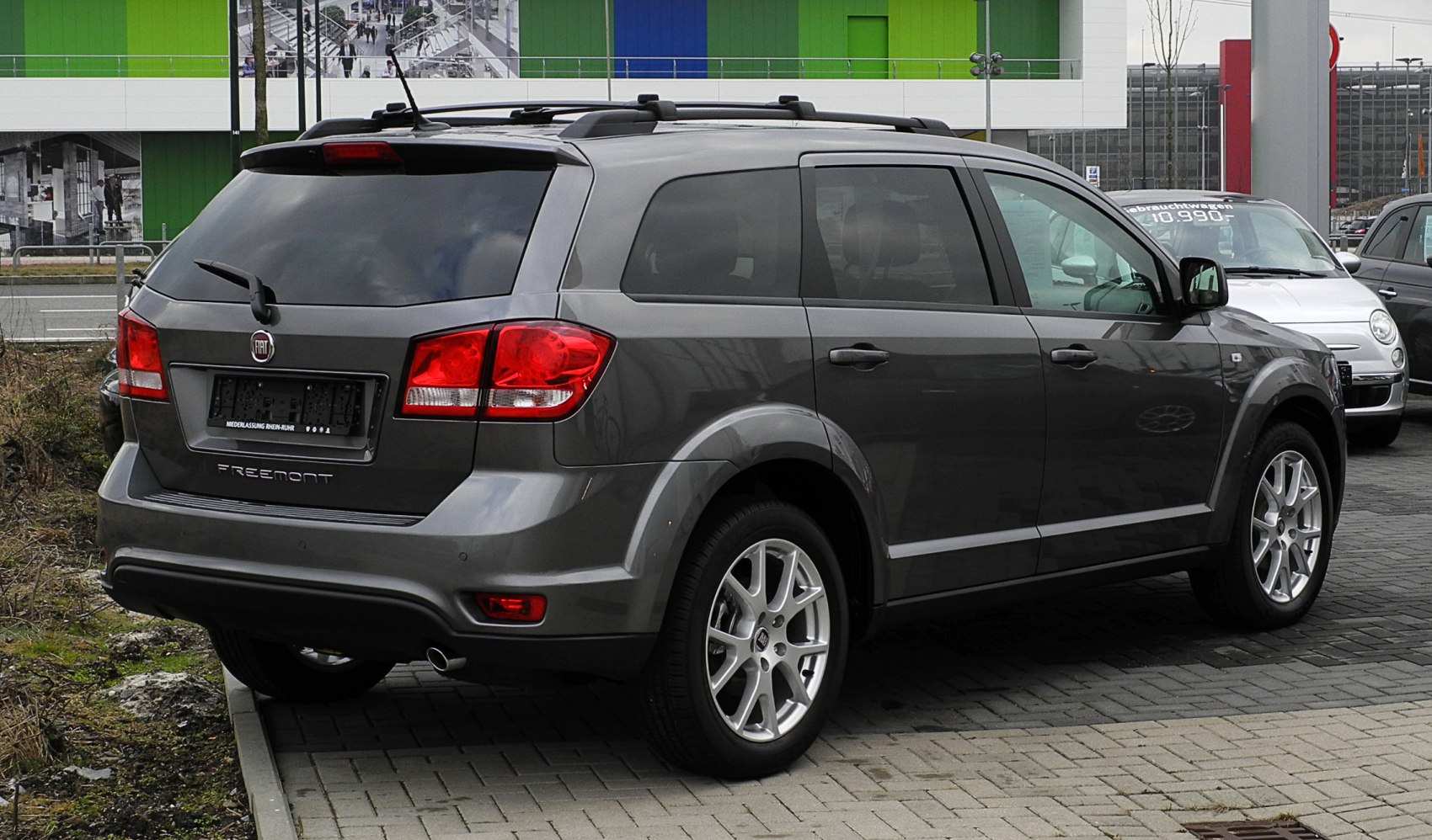 Rear and side profile of an SUV with alloy wheels and roof rails