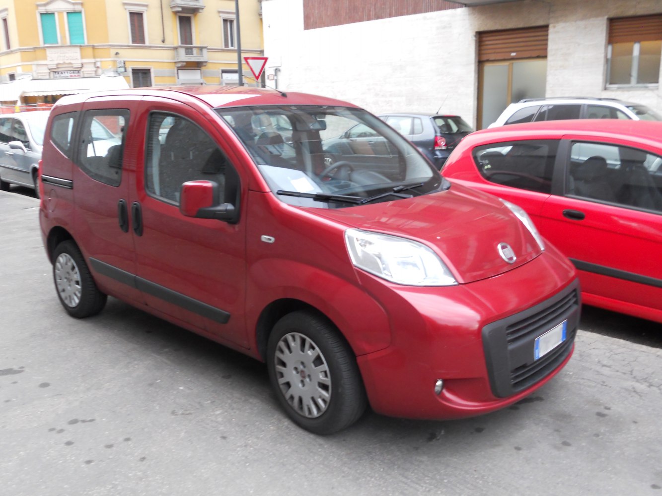 Red compact MPV with sliding rear doors and large windows