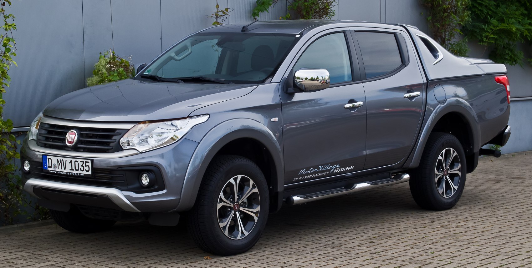 Gray pickup truck front side view with double cab and alloy wheels