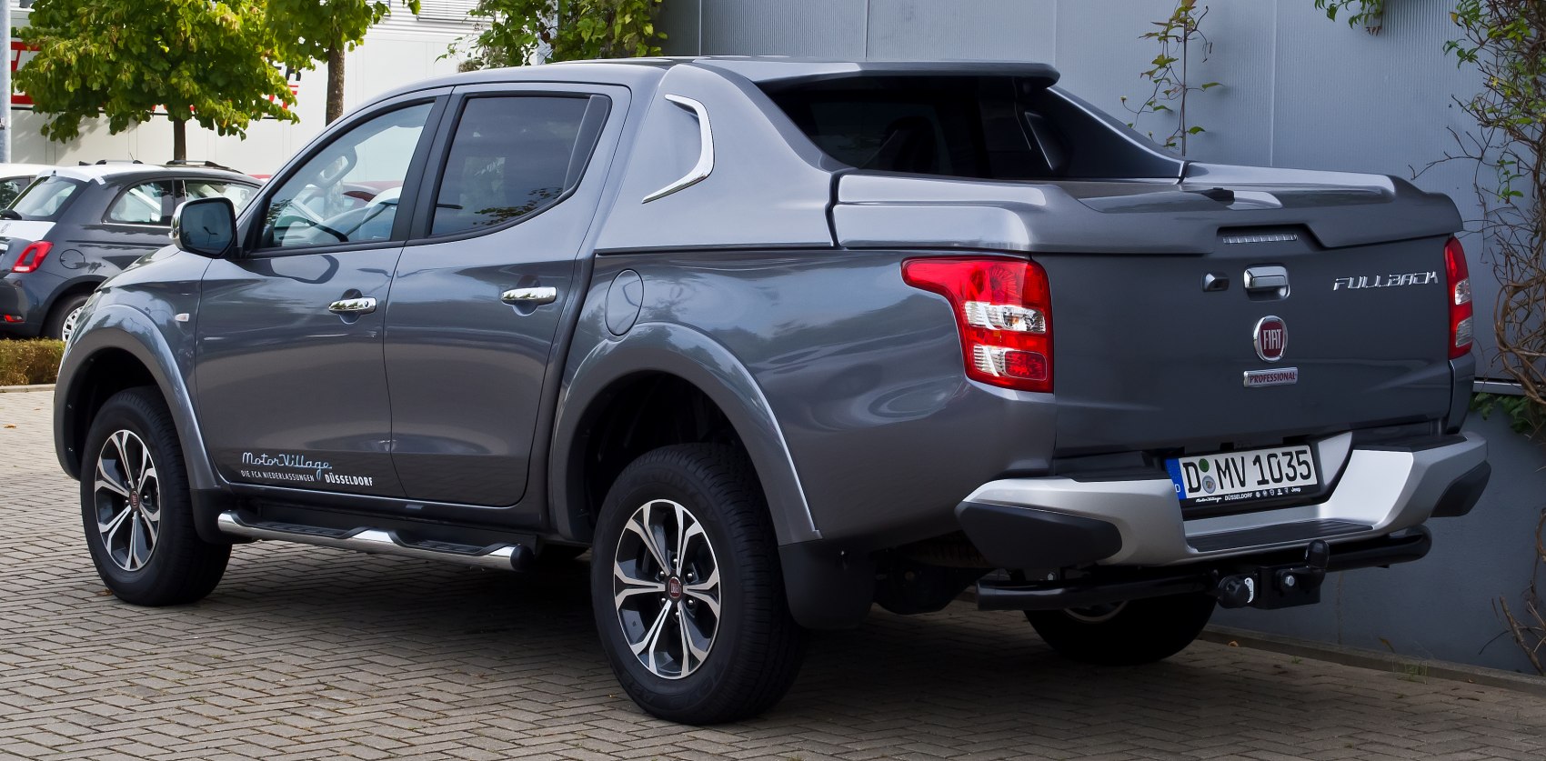 Pickup truck rear and side profile with double cab and alloy wheels