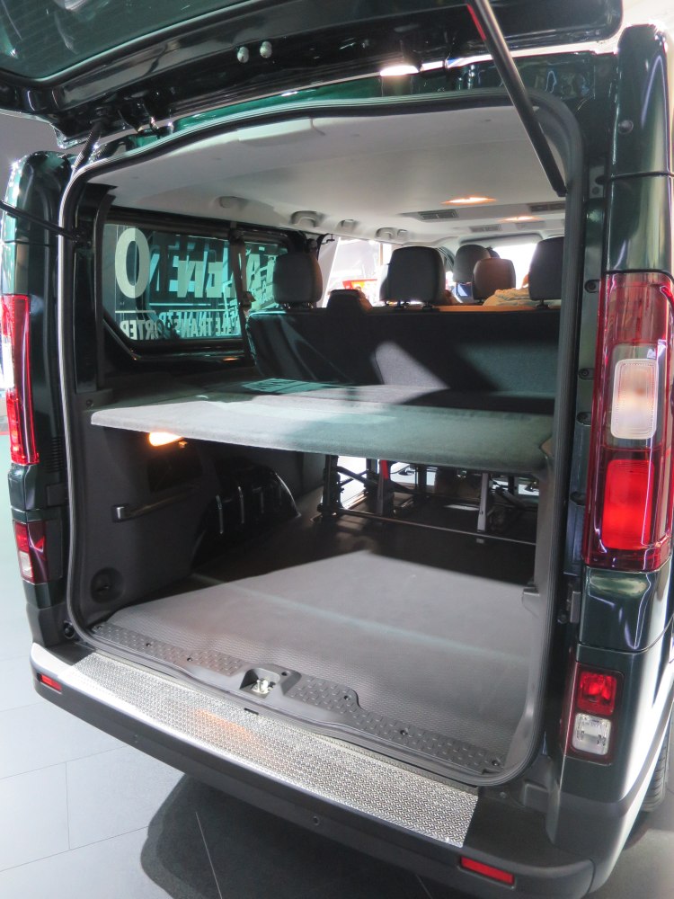 Rear cargo space with storage shelf in multipurpose van