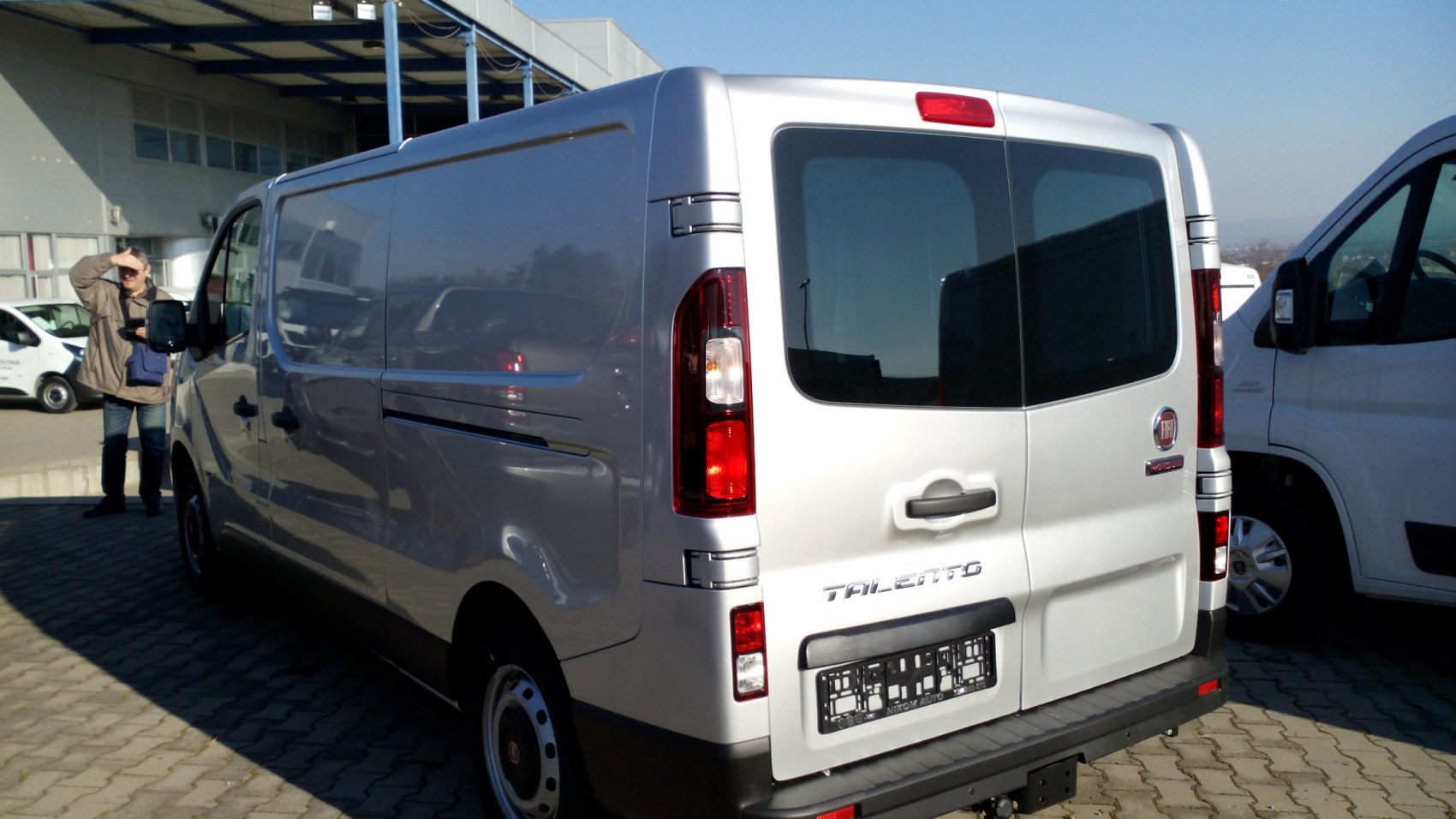 Rear view of a commercial van with distinct taillights and rear windows