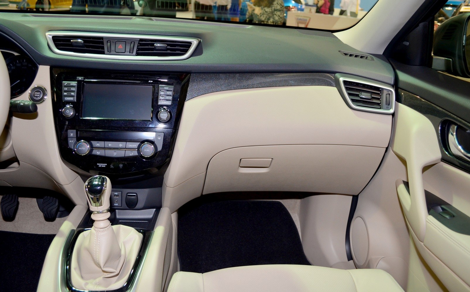 Modern car interior dashboard with center console and manual gear shift.