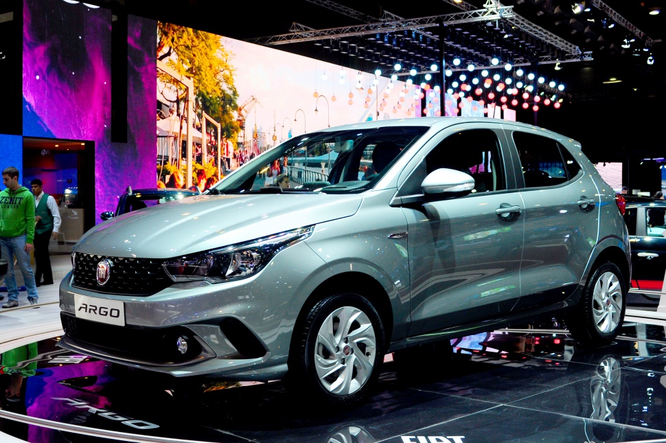 Sleek silver hatchback shown from the front-side at an auto show