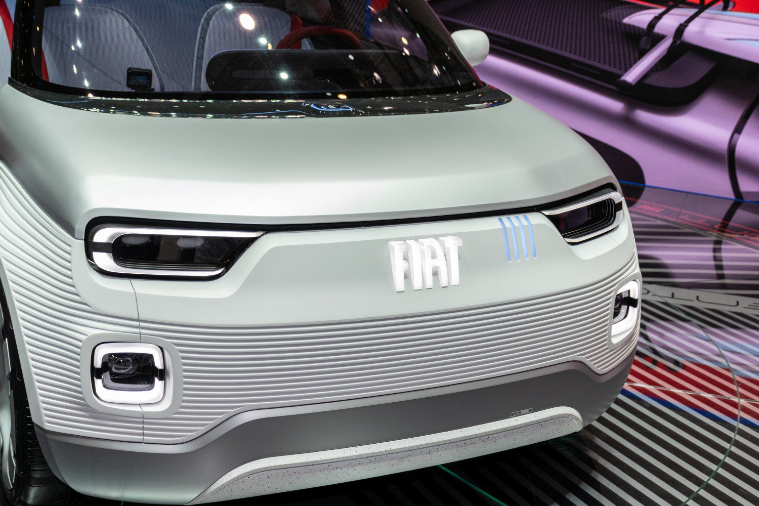 Futuristic front design with unique LED headlights and textured grille.