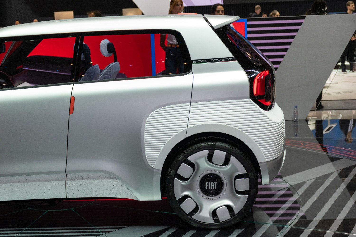 Rear side panel and unique wheel design with ribbed texture and taillight.