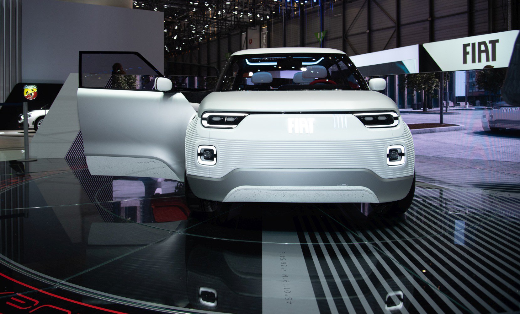 Front view of compact vehicle with LED headlights and open driver's door