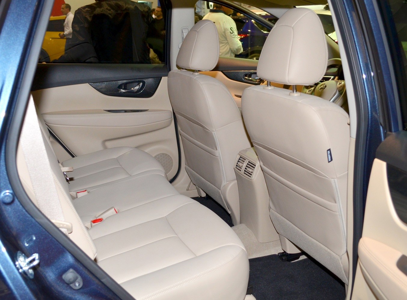 Beige leather rear seats with rear air vents and door panel details