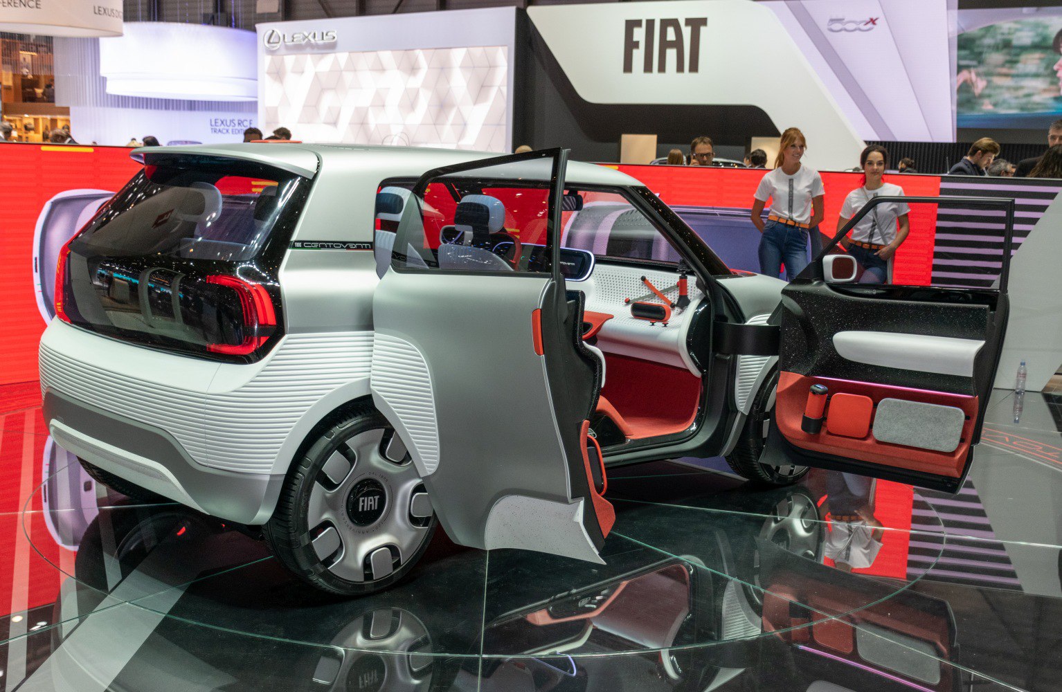 Rear and open door interior view of a futuristic compact electric vehicle.