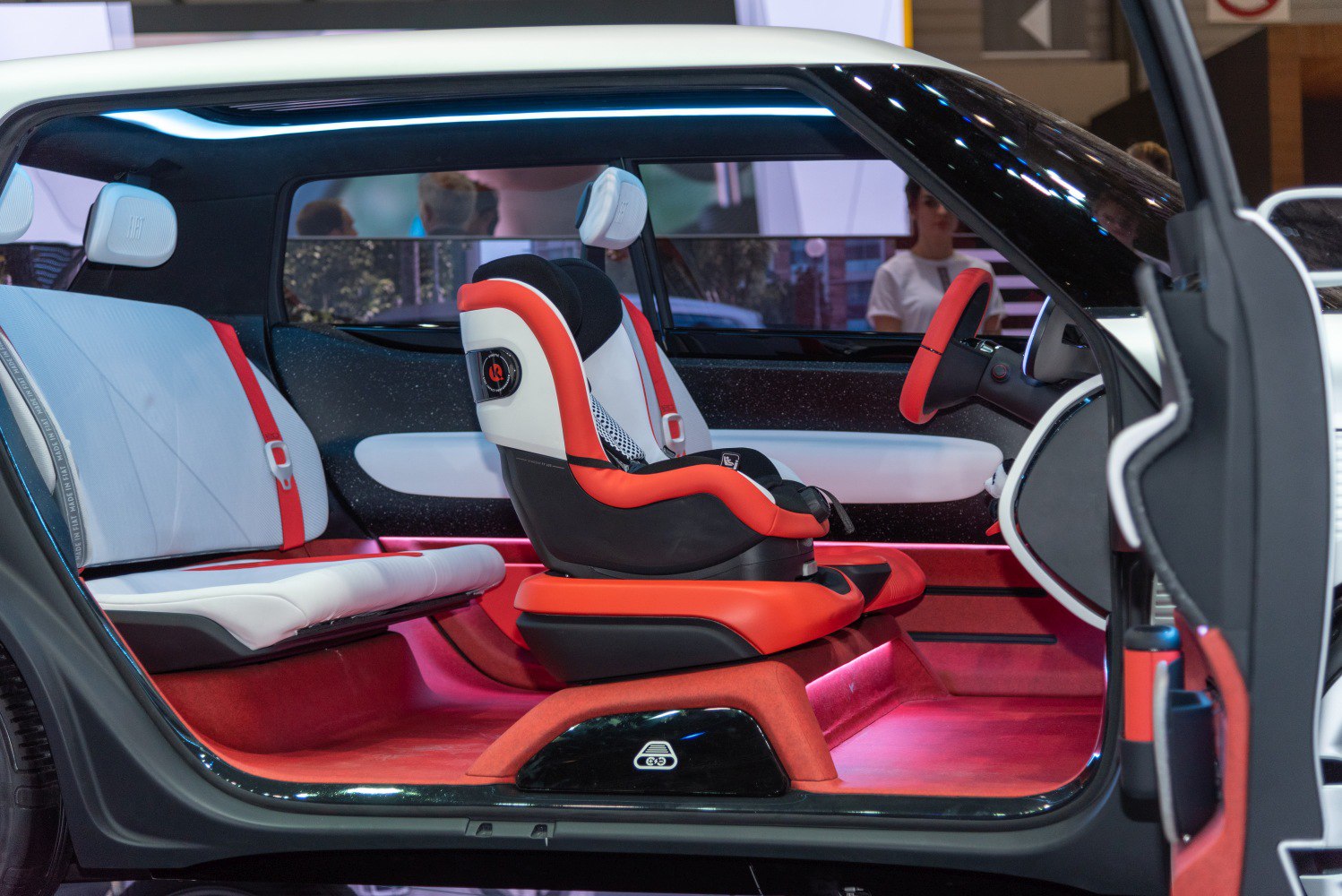 Futuristic modular car interior with red and white seating