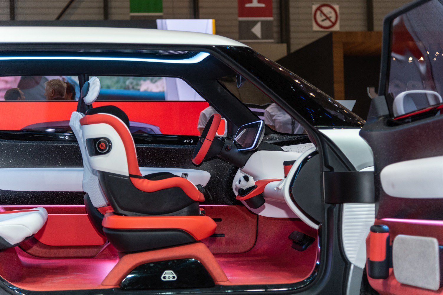 Futuristic car interior with digital dashboard and red-white seats