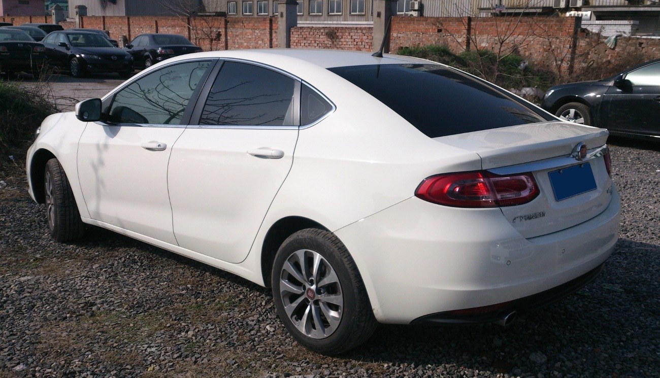 White sedan with tinted windows and aerodynamic rear design
