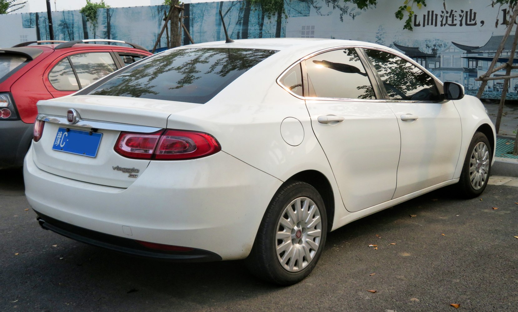 White compact sedan with oval taillights and tinted windows