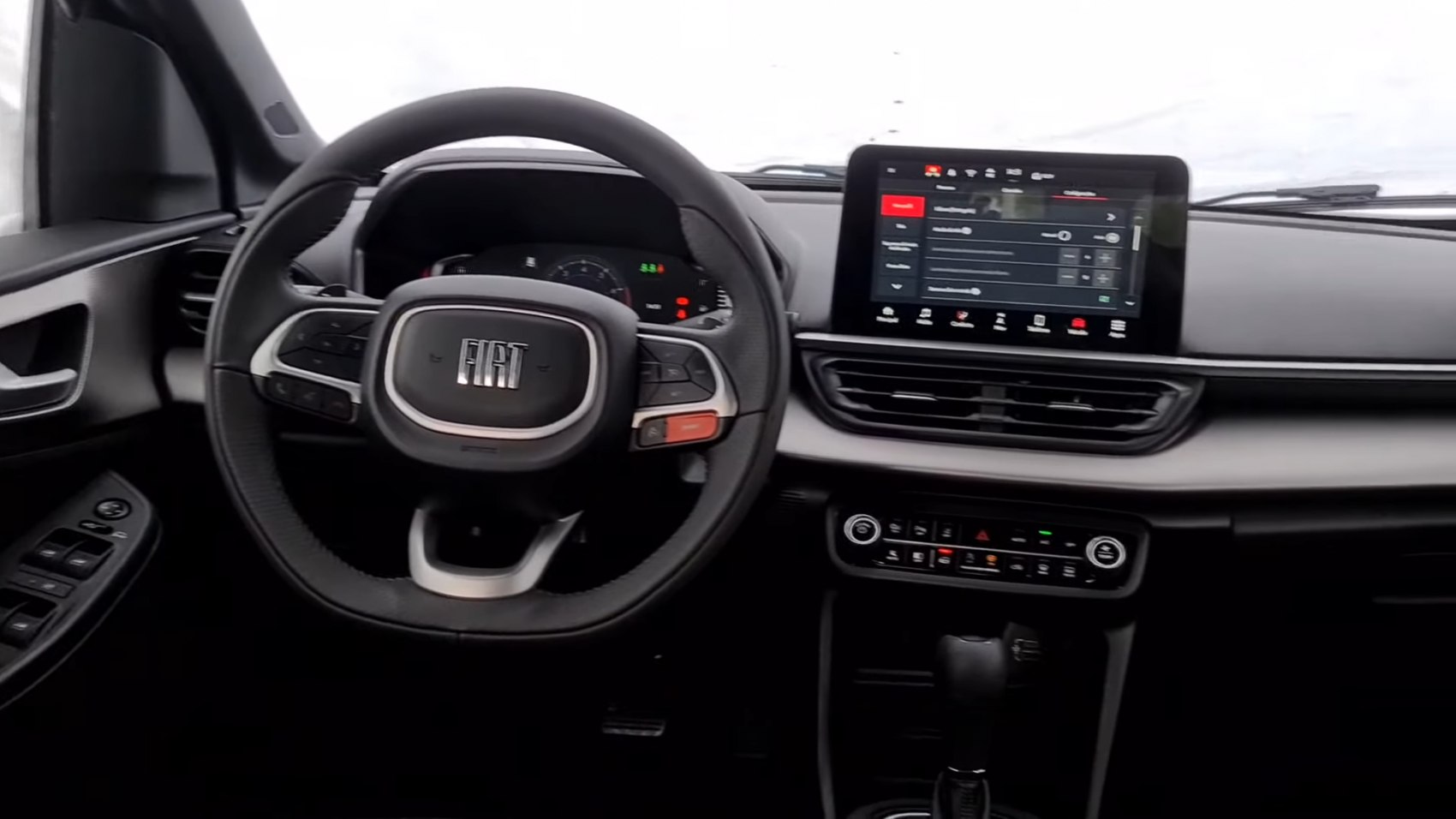 Modern car interior with dashboard, touchscreen, and multifunction steering wheel