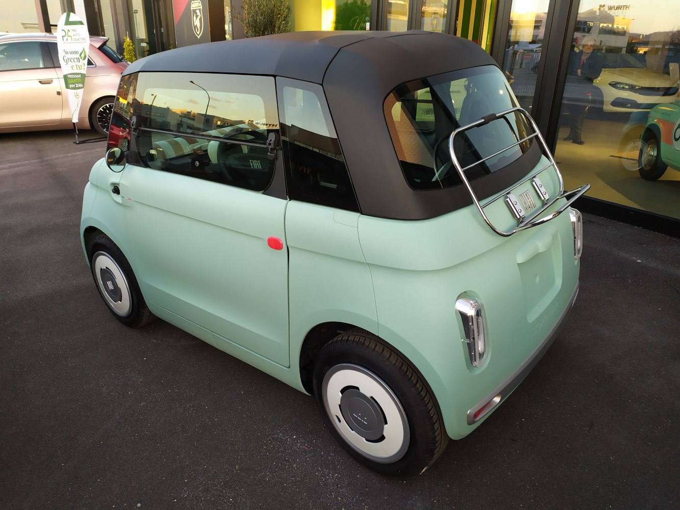 Compact retro-styled electric vehicle with distinctive rounded rear and soft top roof