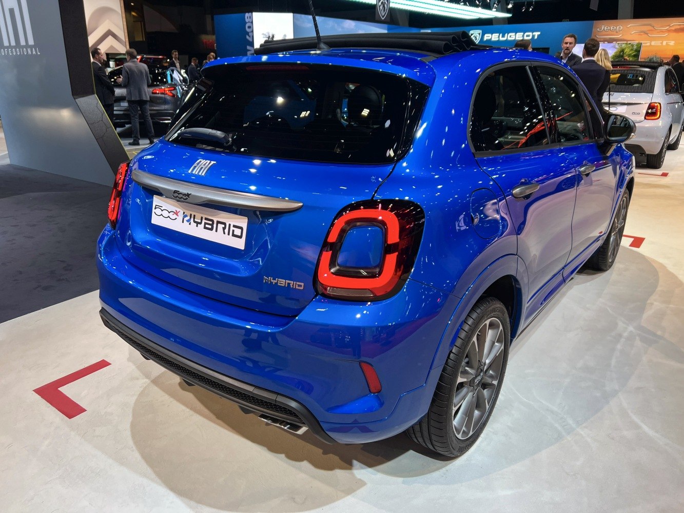 Rear view of blue compact SUV with unique taillights and hybrid badge