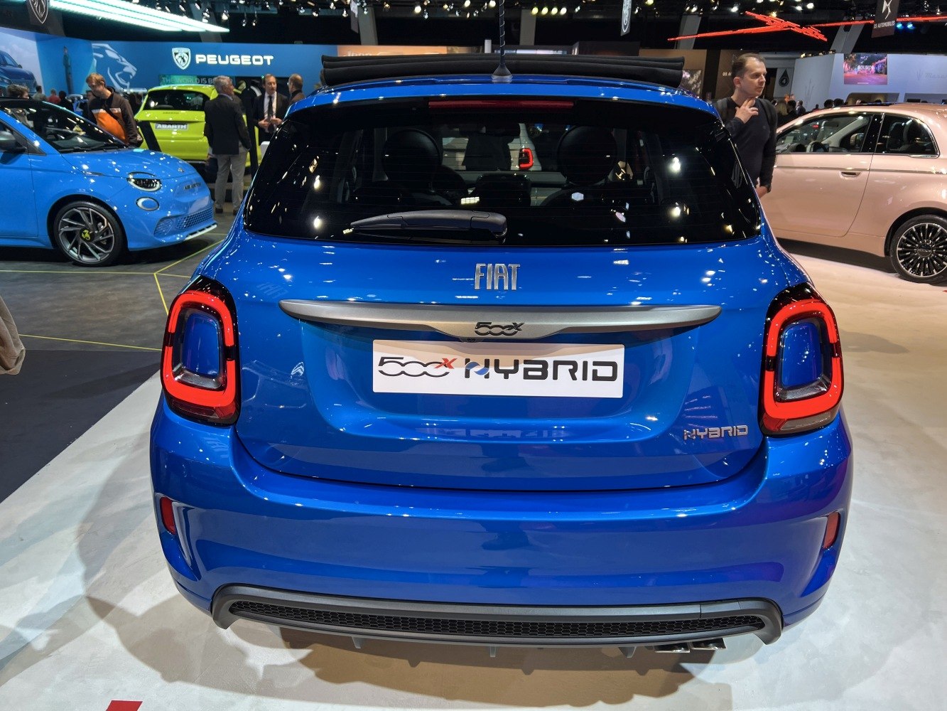 Rear view of blue hybrid hatchback with modern taillights.