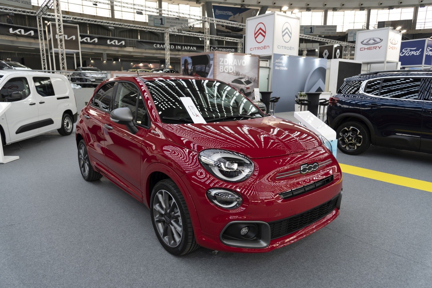 Red compact SUV front with distinctive headlights and sporty styling