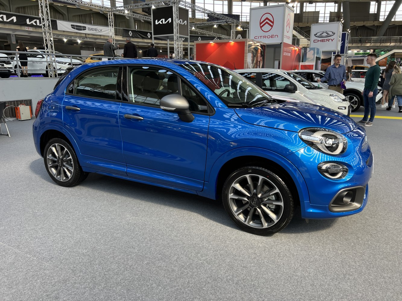 Side view of blue compact SUV with alloy wheels and distinctive headlight design