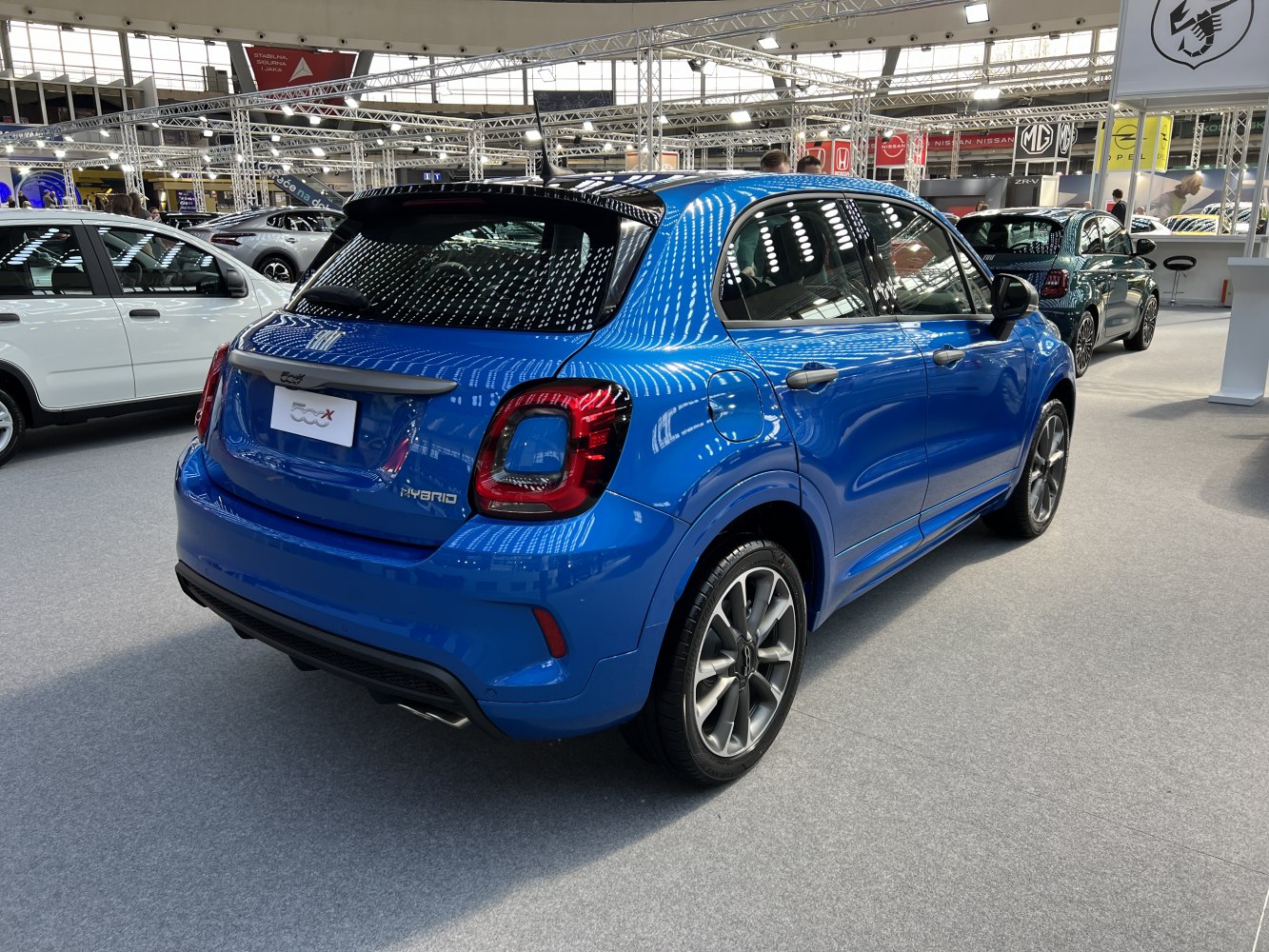 Rear-side view of blue compact SUV with LED taillights and alloy wheels