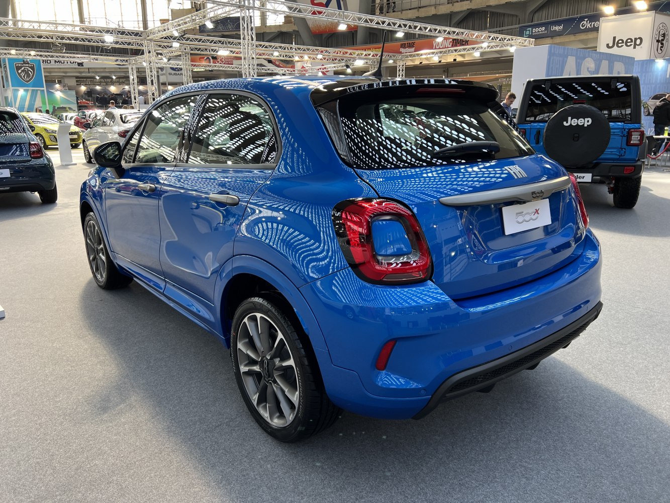 Rear and side view of blue compact SUV with updated taillights and alloy wheels