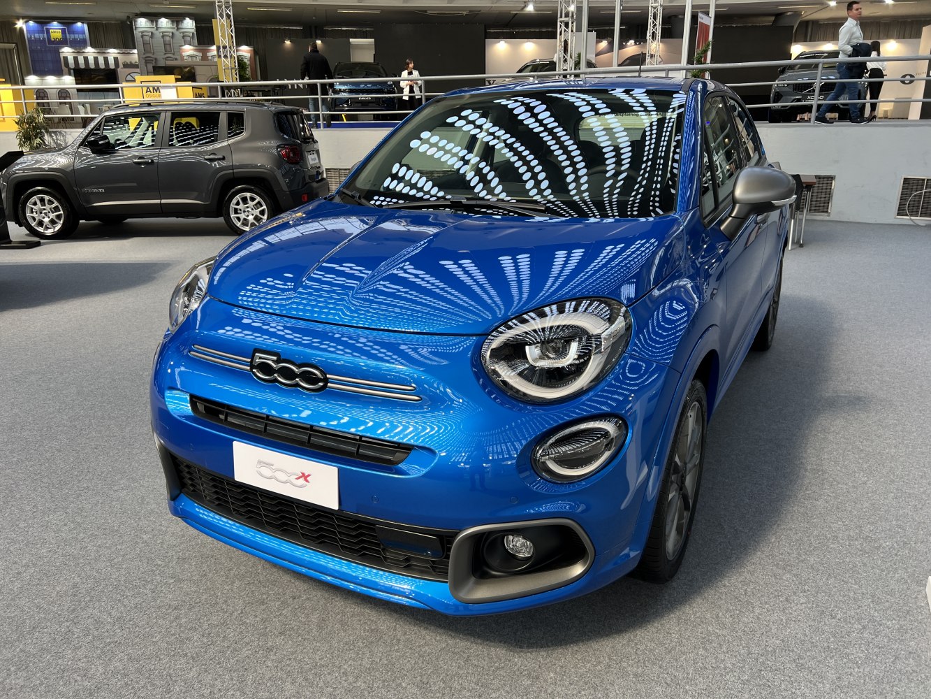 Front view of blue vehicle with round LED headlights and distinctive grille
