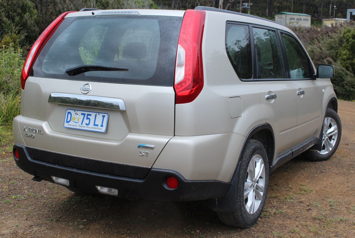 Rear view of SUV with vertical taillights, 4WD badge and alloy wheels