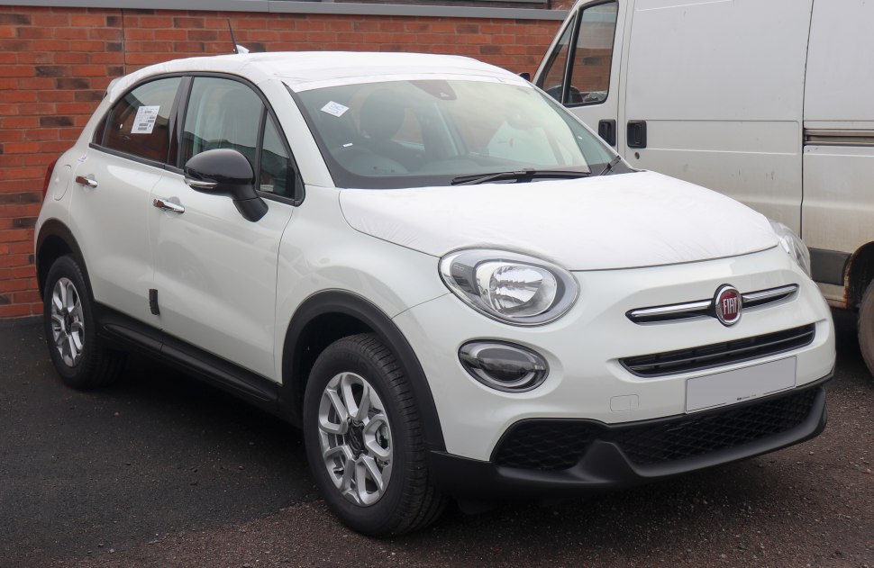 Front side view featuring round headlights and compact SUV body.
