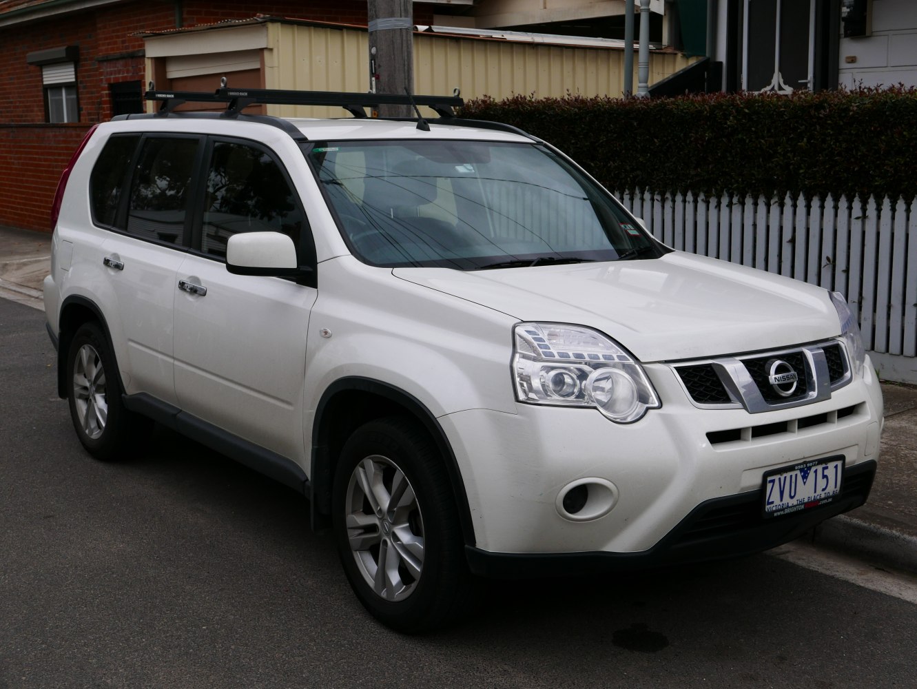 2010 SUV with distinctive headlights and roof rack