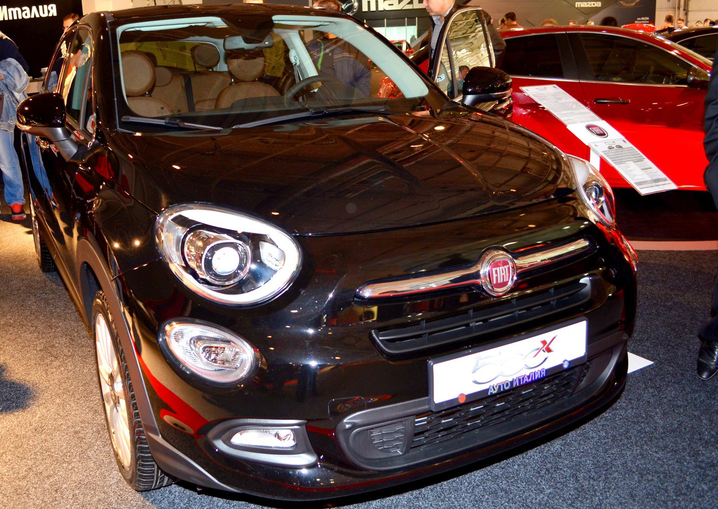 Front view with LED headlights and chrome grille on black vehicle