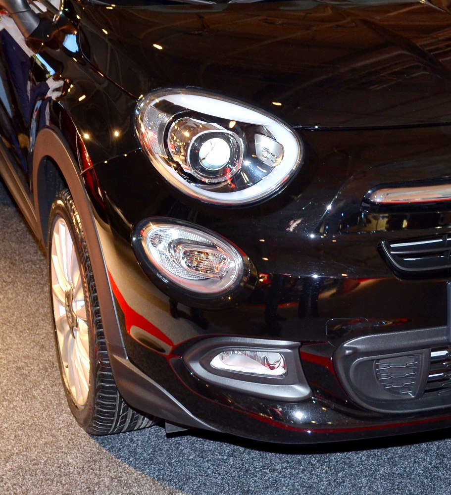 Front headlight and fog lights close-up of a black vehicle