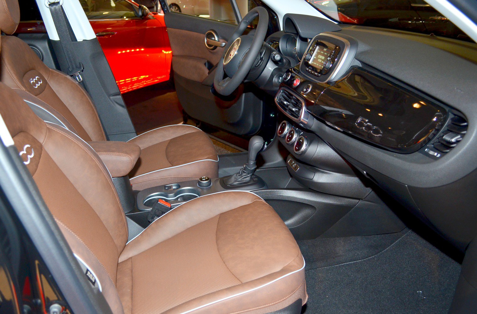 Brown seat upholstery, modern dashboard with central console and steering wheel