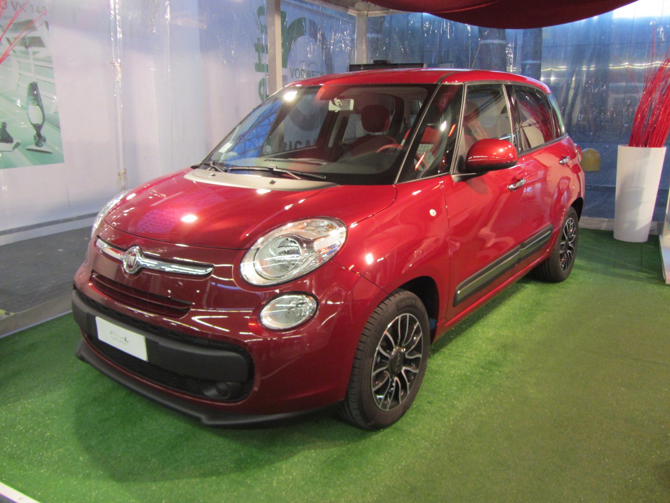 Red compact MPV front side with black alloy wheels