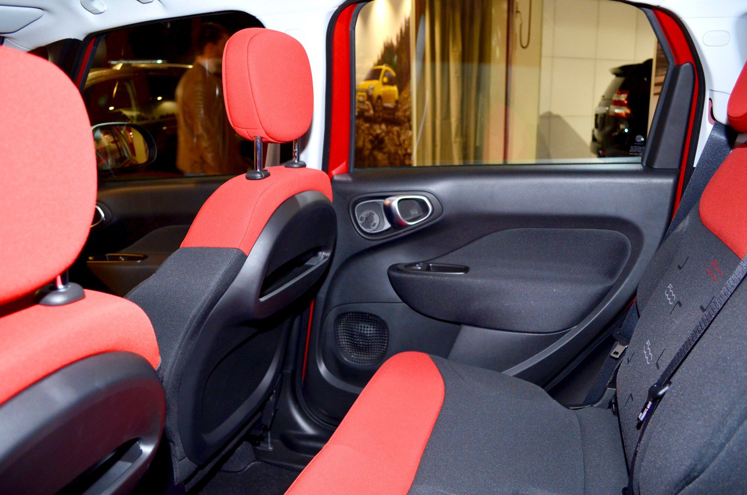 Rear interior seats with red and black upholstery and door panel