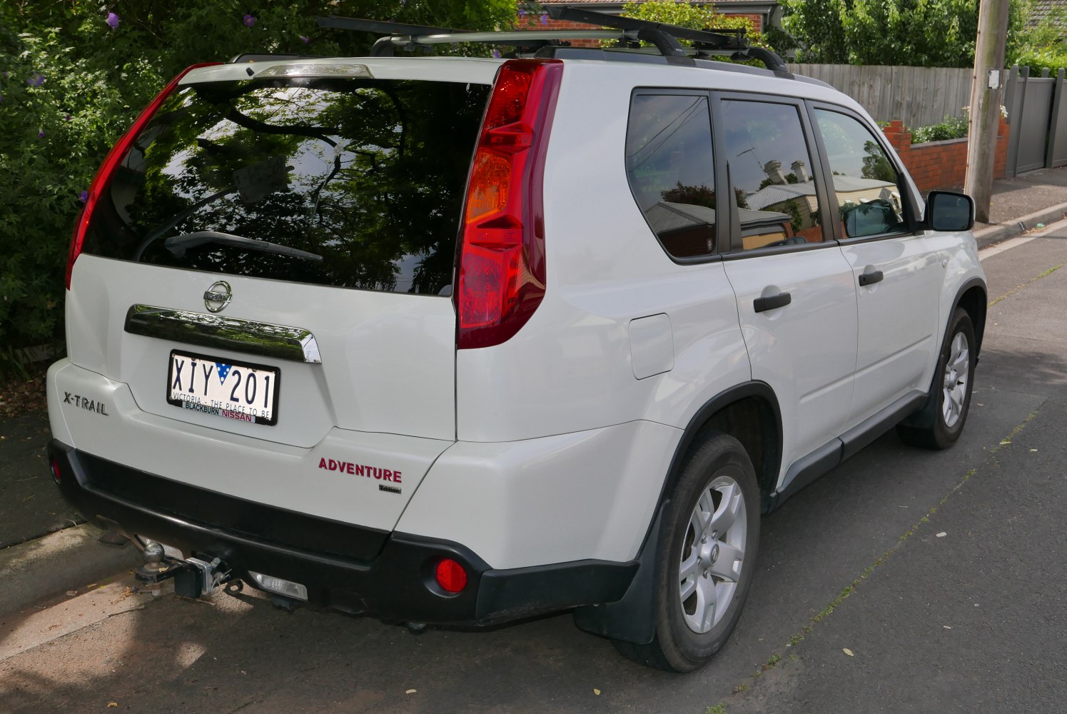 Rear view with vertical tail lights and towing hitch on SUV